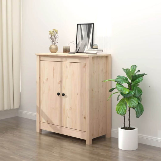 Wooden sideboard in natural pine, featuring two doors, a stylish lamp, and a decorative plant in a cozy living room setting.