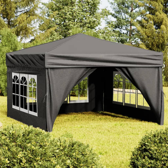 Folding party tent with sidewalls in anthracite color set up in a green outdoor space, perfect for events.