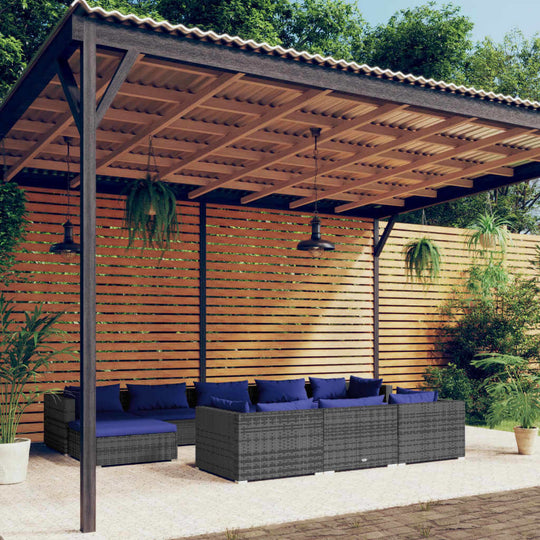 Outdoor lounge seating set under a wooden pergola with blue cushions, perfect for garden relaxation.