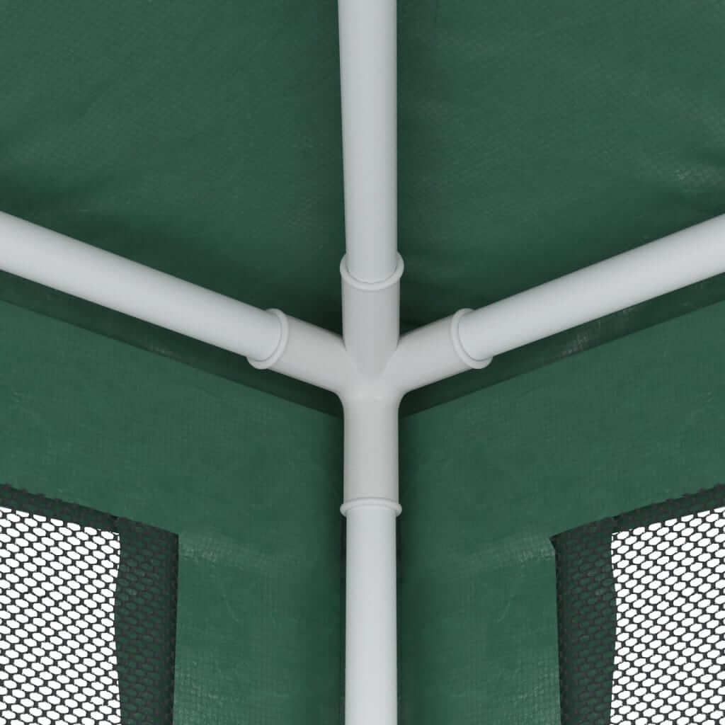 Close-up view of the corner joint of a green party tent with mesh sidewalls and a sturdy iron frame.