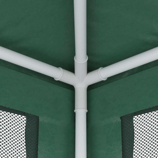 Close-up view of the corner joint of a green party tent with mesh sidewalls and a sturdy iron frame.