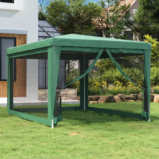 Green 3x4 m party tent with mesh sidewalls in a garden setting, ideal for outdoor furniture and gatherings.