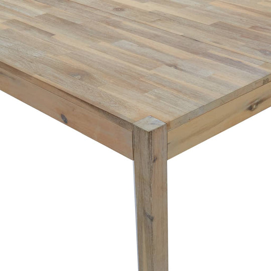 Close-up of solid acacia wood dining table showcasing the natural grain and sturdy frame.