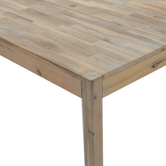 Close-up of a solid acacia wood dining table showing the sturdy frame and spacious tabletop design.