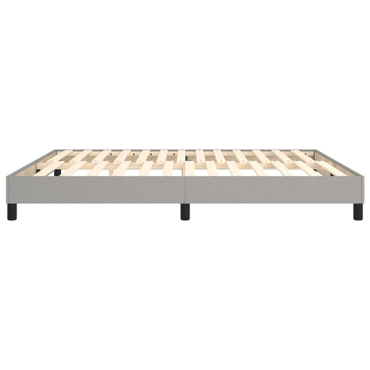 Light grey bed frame without mattress, 180x200 cm, featuring sturdy plywood slats and supportive legs for stability.