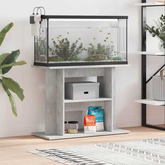 Aquarium stand in concrete grey with fish tank, featuring storage for aquatic supplies and greenery in a modern living space.