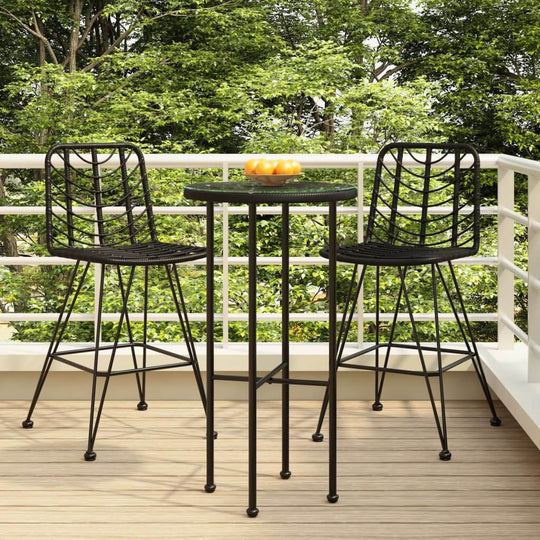 Black outdoor bar stools and round table on a balcony, featuring PE rattan and steel for sturdy, stylish furniture.