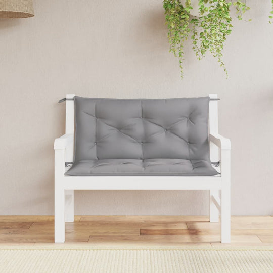 Grey garden bench cushion on a white outdoor sofa, perfect for enhancing outdoor furniture comfort and style.