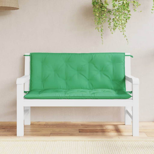 Green outdoor garden bench cushions on a white wooden sofa, enhancing outdoor living space comfort and style.