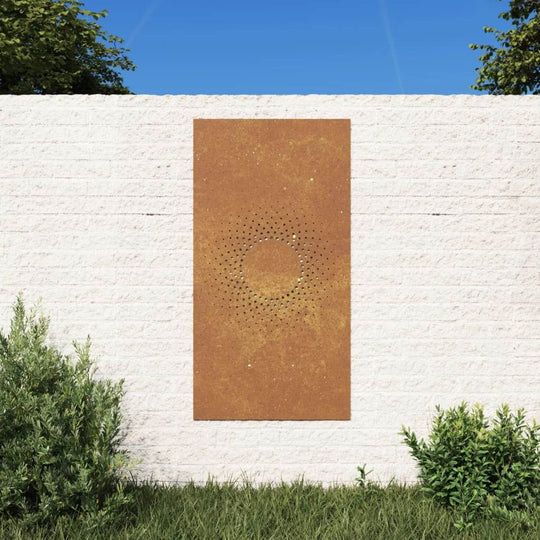 Corten steel garden wall decoration in sun design against white wall, enhancing outdoor space with unique art.