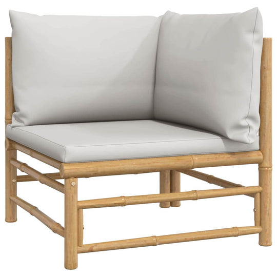 Light grey cushioned corner seat of a bamboo garden lounge set for outdoor comfort.