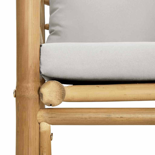 Close-up of a bamboo garden sofa with light cushions, showcasing durable and elegant outdoor furniture design.