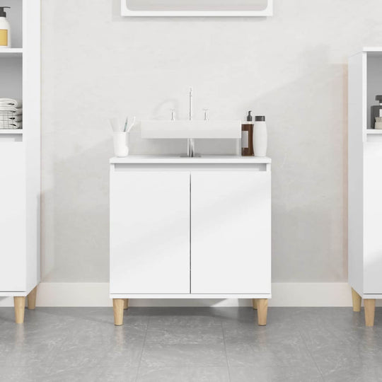 White sink cabinet made of engineered wood, featuring two doors and stylish legs, perfect for bathroom storage.