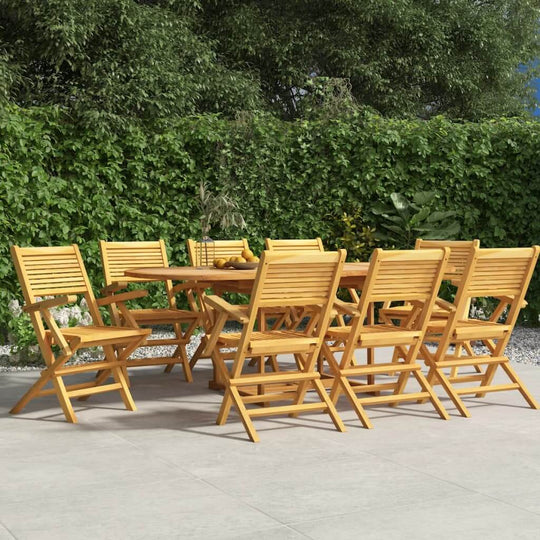 Set of 8 folding teak garden chairs around a wooden table in a lush outdoor setting, perfect for family gatherings.