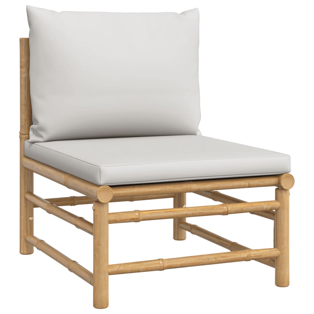 Lounge chair from a bamboo garden sofa set with light grey cushions for outdoor seating.