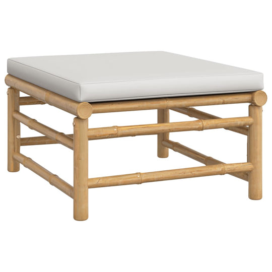 Bamboo outdoor lounge set table with light grey cushion, perfect for garden seating and relaxation.