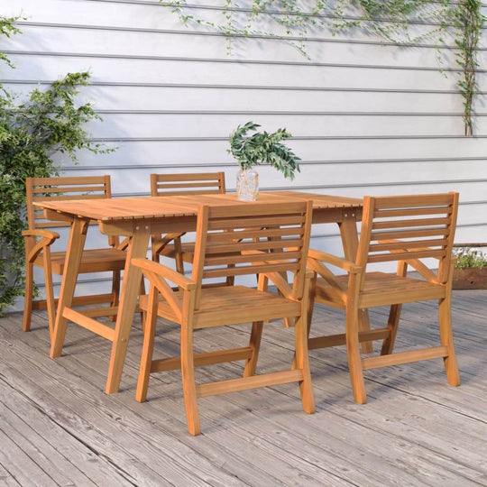 Set of 4 solid acacia garden chairs and wooden table on a patio with greenery, perfect for outdoor furniture settings.