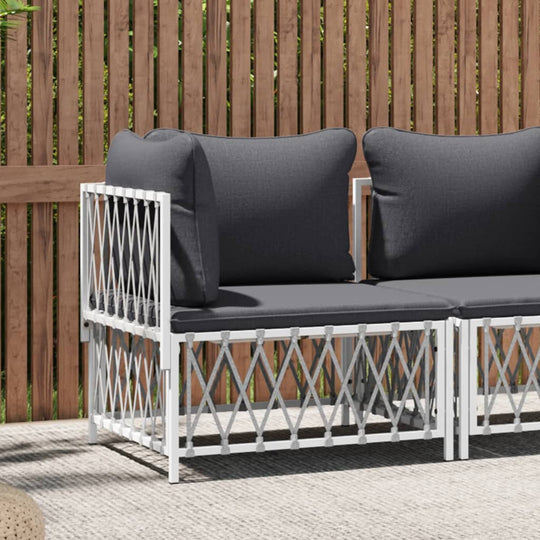 Stylish garden corner sofa with dark cushions and white woven frame, perfect for outdoor lounging and dining.