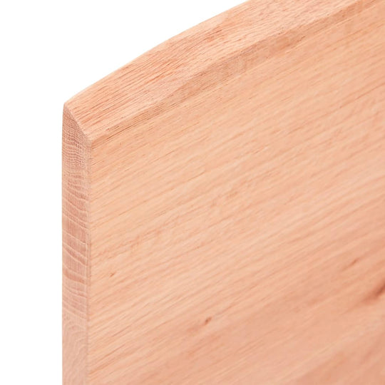 Close-up of light brown solid oak wood tabletop edge, showcasing natural grain and texture for furniture or outdoor use.