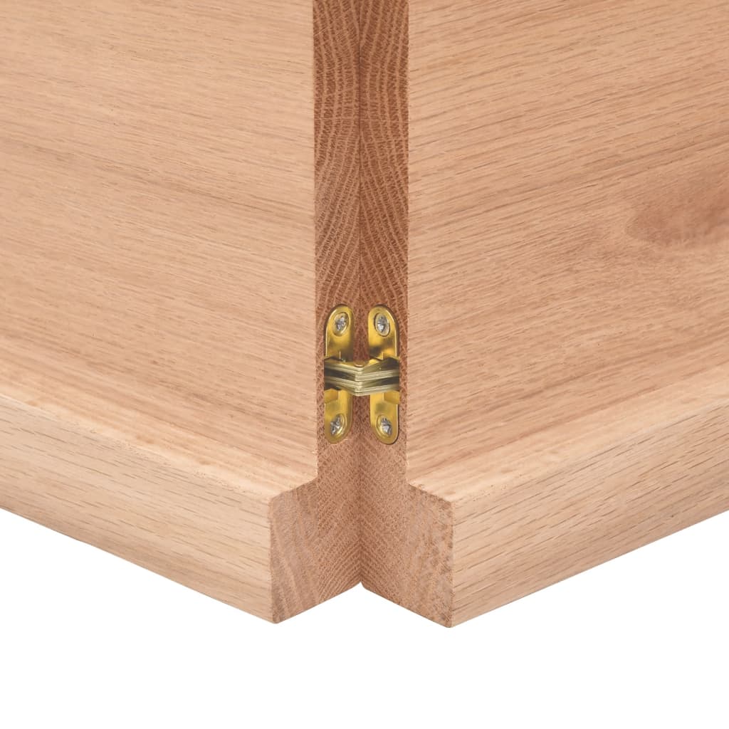 Close-up of a wooden table edge with brass hinge, showcasing the solid construction and design detail for furniture.