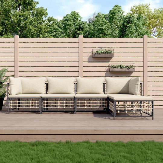 5 Piece Garden Lounge Set in Anthracite Poly Rattan with Cushions on Deck, Surrounded by Greenery and Fencing.