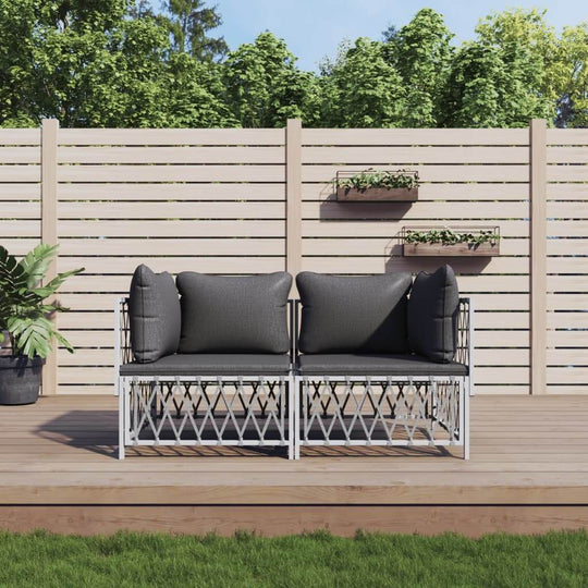 2 piece garden lounge set with gray cushions on wooden deck, surrounded by greenery and a decorative fence.