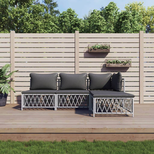 4 Piece garden lounge set with cushions, stylish outdoor furniture on wooden deck with greenery in the background.