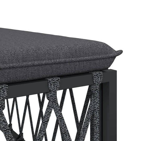 Close-up of gray cushion on a durable woven fabric outdoor lounge bench frame with powder-coated steel.