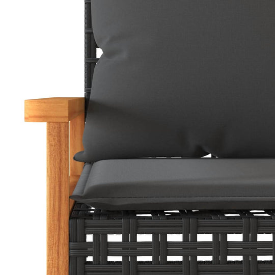 Cushioned lounge sofa featuring black poly rattan weave and wooden armrest, perfect for outdoor furniture setups.