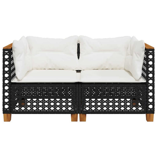 Garden sofa corner with white cushions, black poly rattan material for outdoor relaxation and comfort.