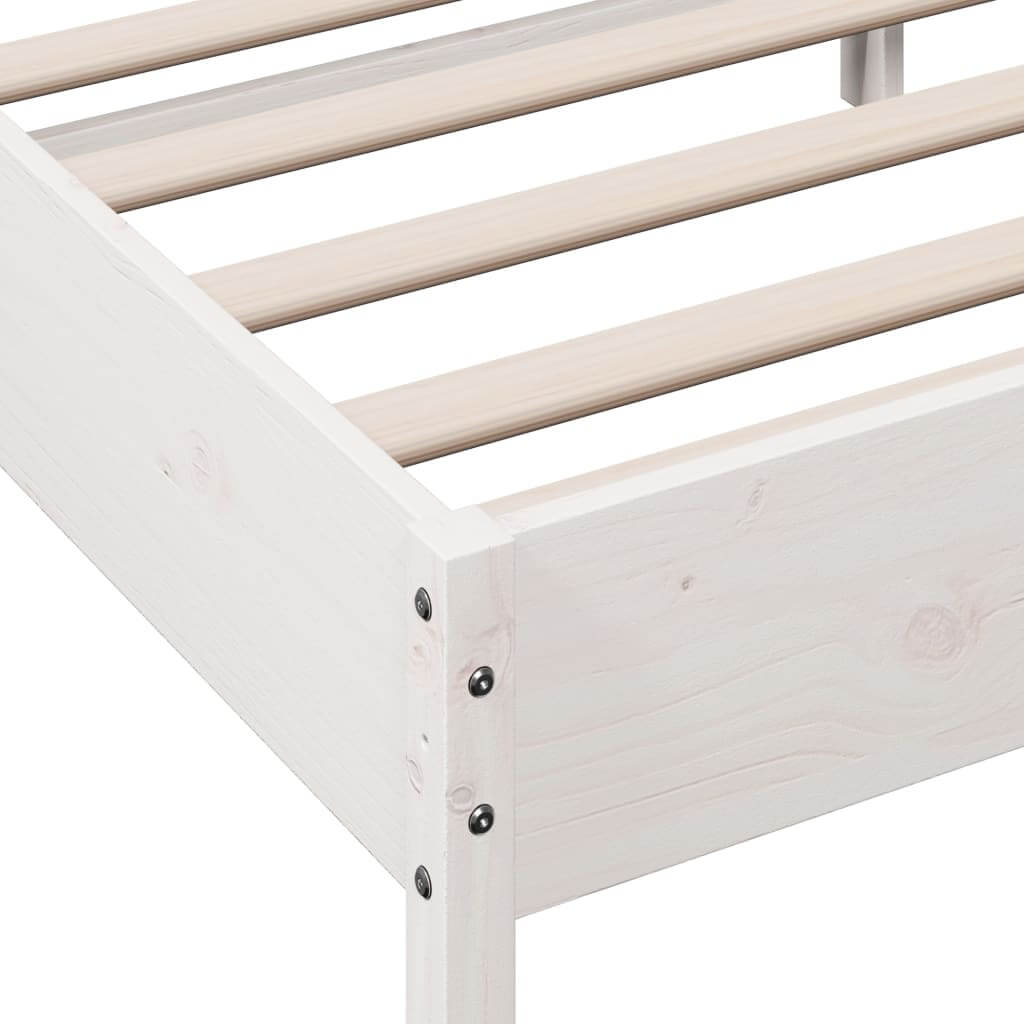 Close-up of a white solid wood bed frame with plywood slats for optimal mattress support and rustic design.