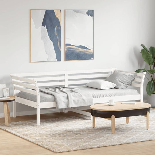 White solid wood day bed 90x200 cm, ideal for lounge or bedroom, styled with modern decor and cozy accessories.