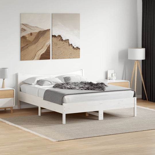 Modern white bed frame in a stylish bedroom with art, showcasing solid pine wood and cozy decor accents.