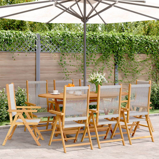 Set of 8 grey solid acacia reclining garden chairs around a wooden table under a patio umbrella in a lush outdoor setting.