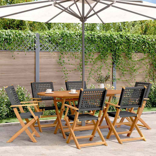 Folding garden chairs set under a parasol, surrounded by greenery, perfect for outdoor furniture and relaxation.