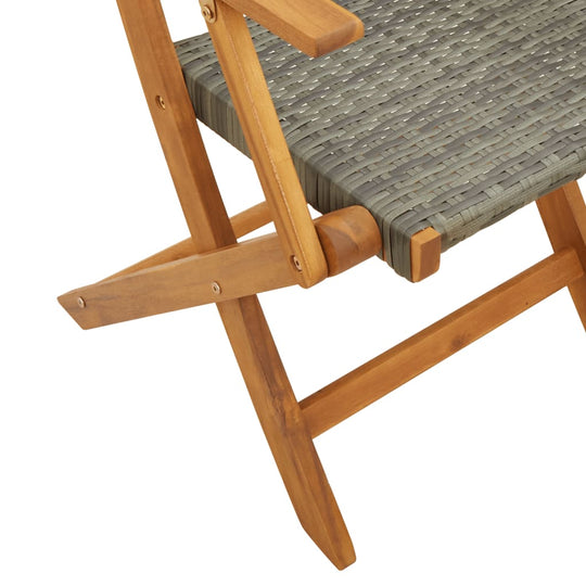 Folding garden chair featuring grey poly rattan seat and solid wood frame, ideal for outdoor seating.