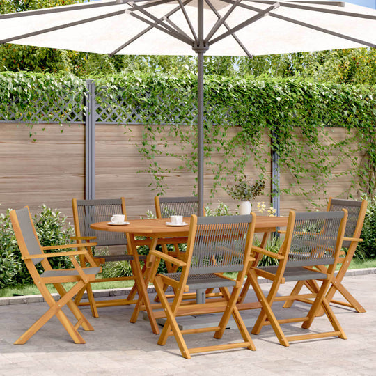 Folding garden chairs and table set in a lush outdoor setting under an umbrella, ideal for relaxing and entertaining.