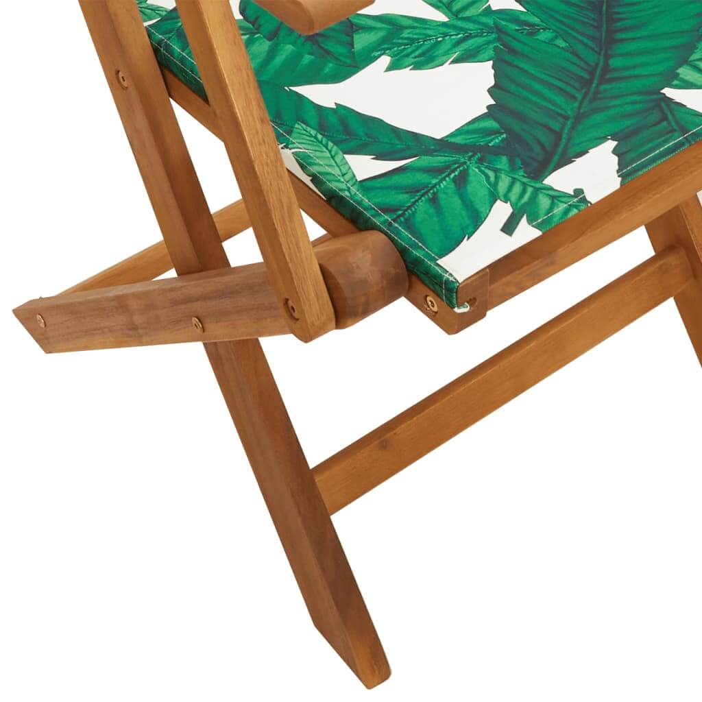 Detail of folding garden chair with green leaf fabric and solid acacia wood frame, ideal for outdoor furniture and lounging.