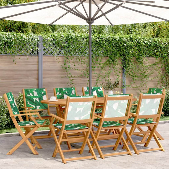 Folding garden chairs with green fabric under patio umbrella in a lush outdoor setting, ideal for relaxing and entertaining.