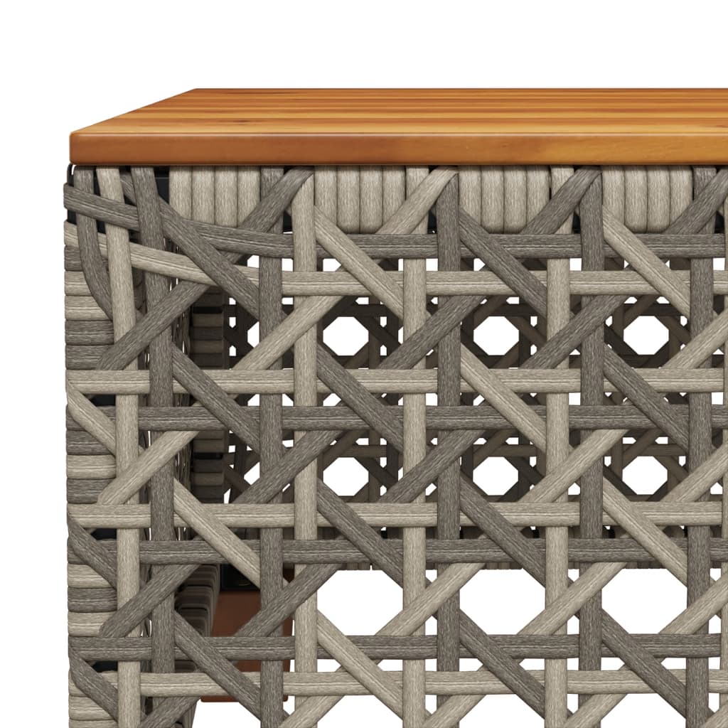 Close-up of grey poly rattan weaving and wooden tabletop on an outdoor furniture piece, showcasing durability and style.