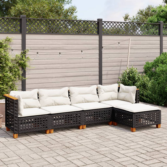 5 Piece black poly rattan garden sofa set with cushions in outdoor patio setting, ideal for lounging and relaxation.