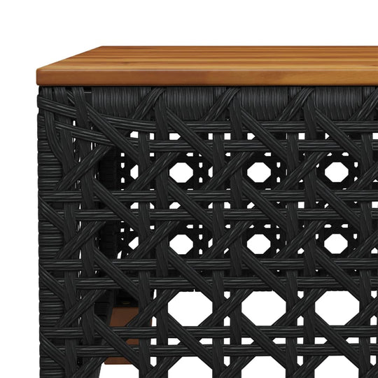 Close-up of a black poly rattan table with a wooden top, showcasing durable outdoor furniture design.