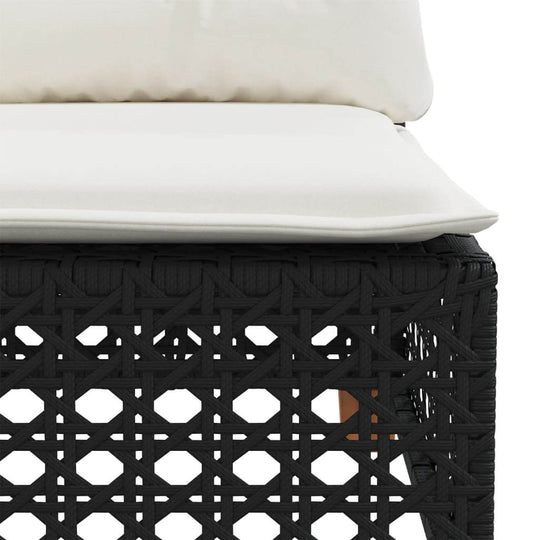 Close-up of cushioned black poly rattan sofa seat, showcasing durable outdoor furniture design.