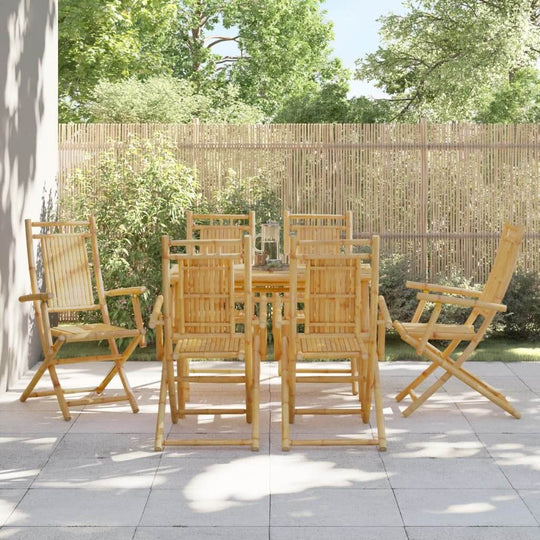 Elegant bamboo folding garden chairs set for outdoor dining on a patio, showcasing durable furniture design in a lush setting.