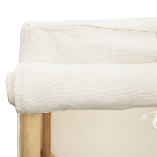 Close-up of a rolled fabric cover on a wooden furniture piece, showcasing its cream color and soft texture.