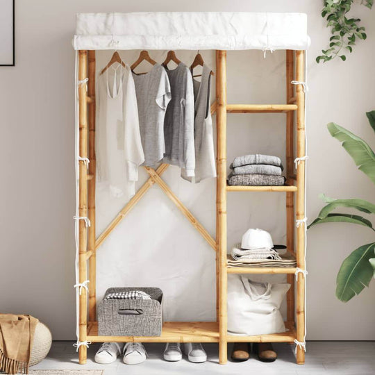 Bamboo wardrobe with hanging clothes and shelves, practical furniture for home decor and storage solutions.