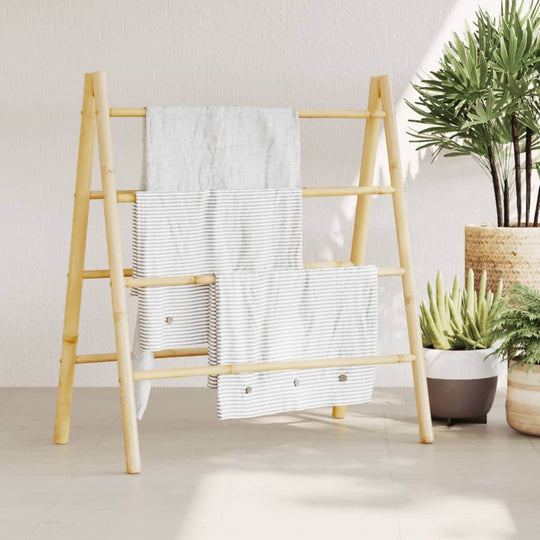 Double bamboo towel ladder with 4 rungs displaying towels, ideal for stylish storage in any room, enhancing home decor.