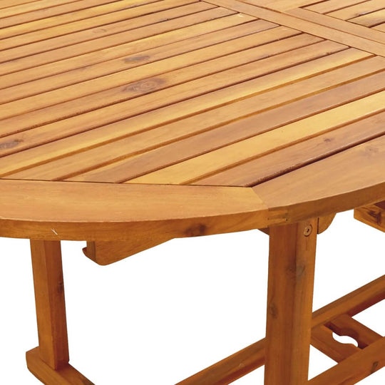 Close-up of a round acacia wood tabletop showcasing natural grain patterns and sturdy construction for outdoor dining.