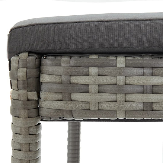 Close-up of a grey poly rattan garden bar set with a padded cushion, showcasing modern outdoor furniture design.