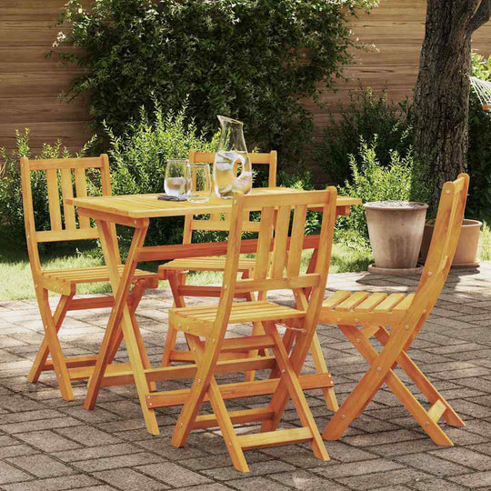 Garden Chair Folding 4 pcs Oil Natural UAE set on a patio with a small table and glasses, ideal for outdoor use.